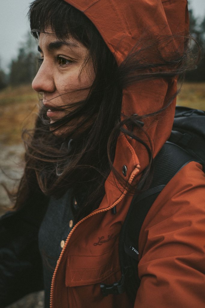 woman out hiking in bad weather