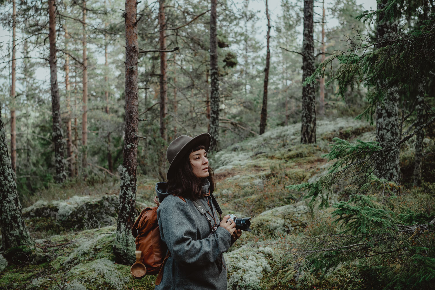 woman with a camera in a forest