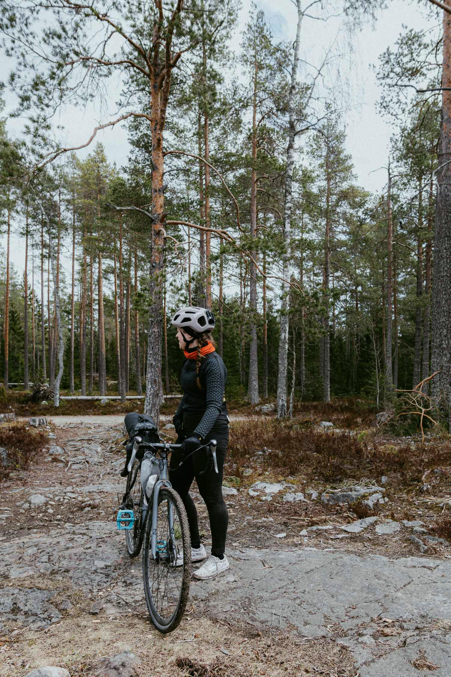 woman in a forest with her bike