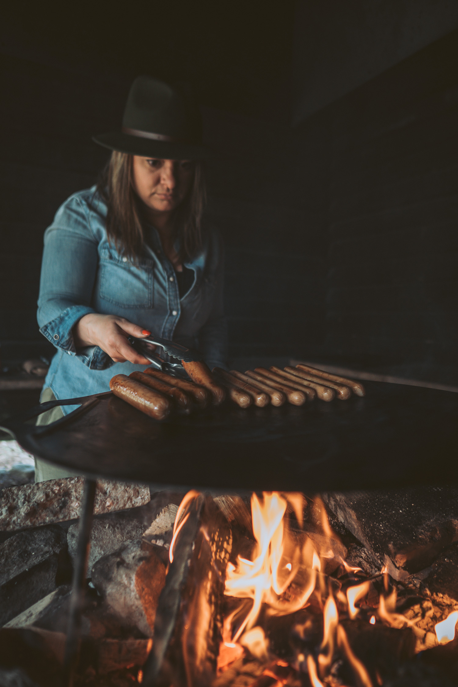 woman grilling hot dogs