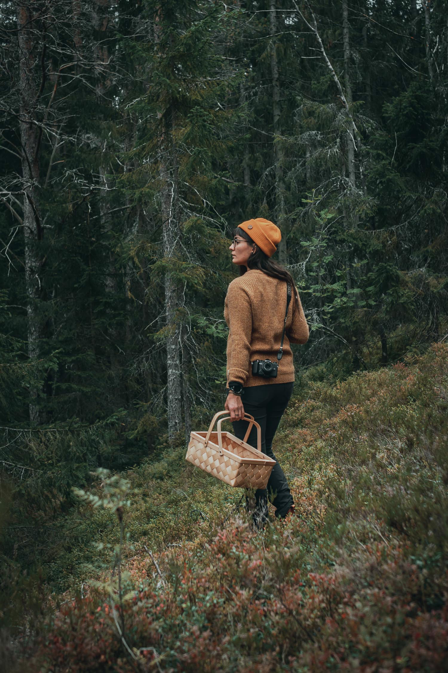 woman with basket and camera in a forest