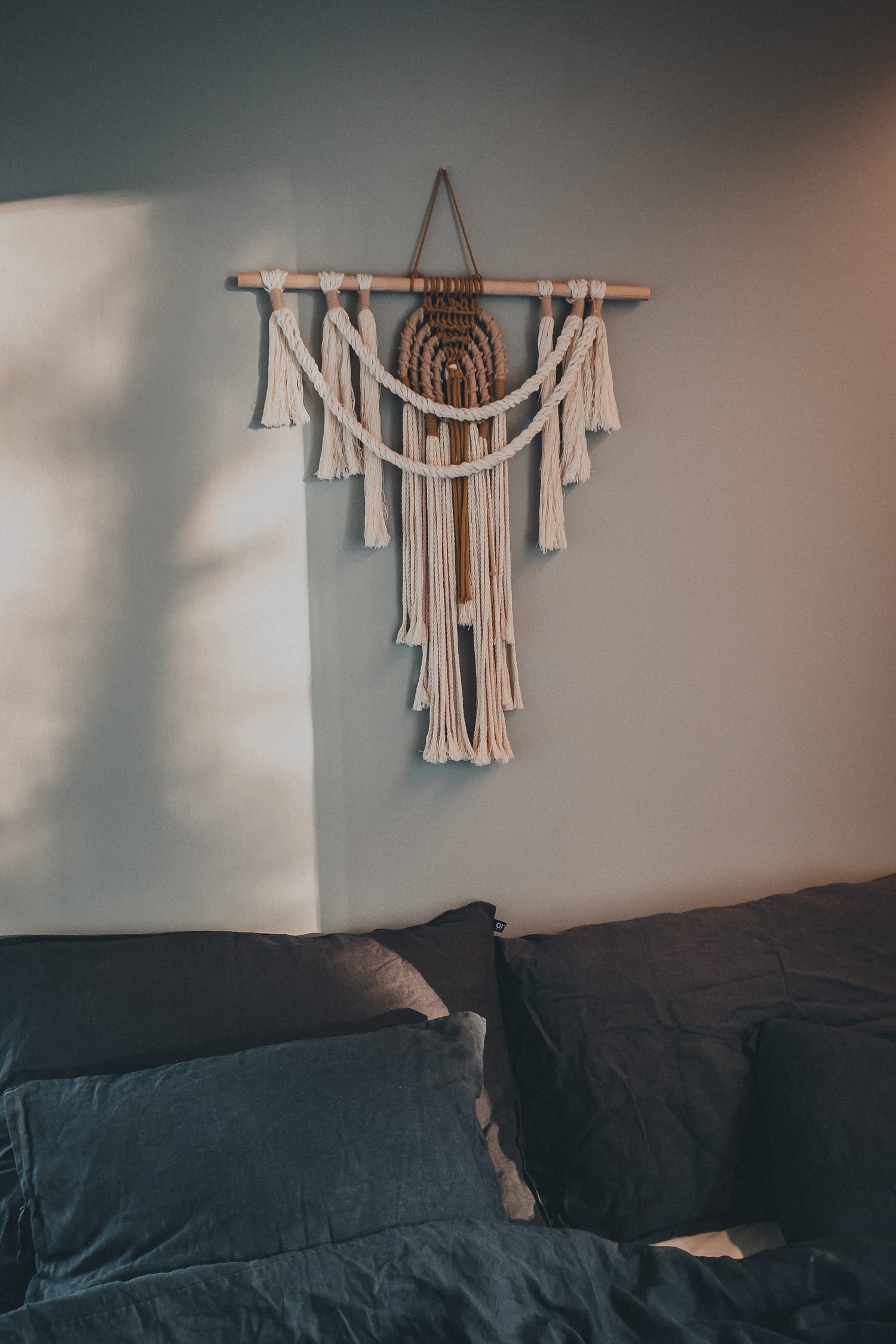 bed with macrame hanger above it