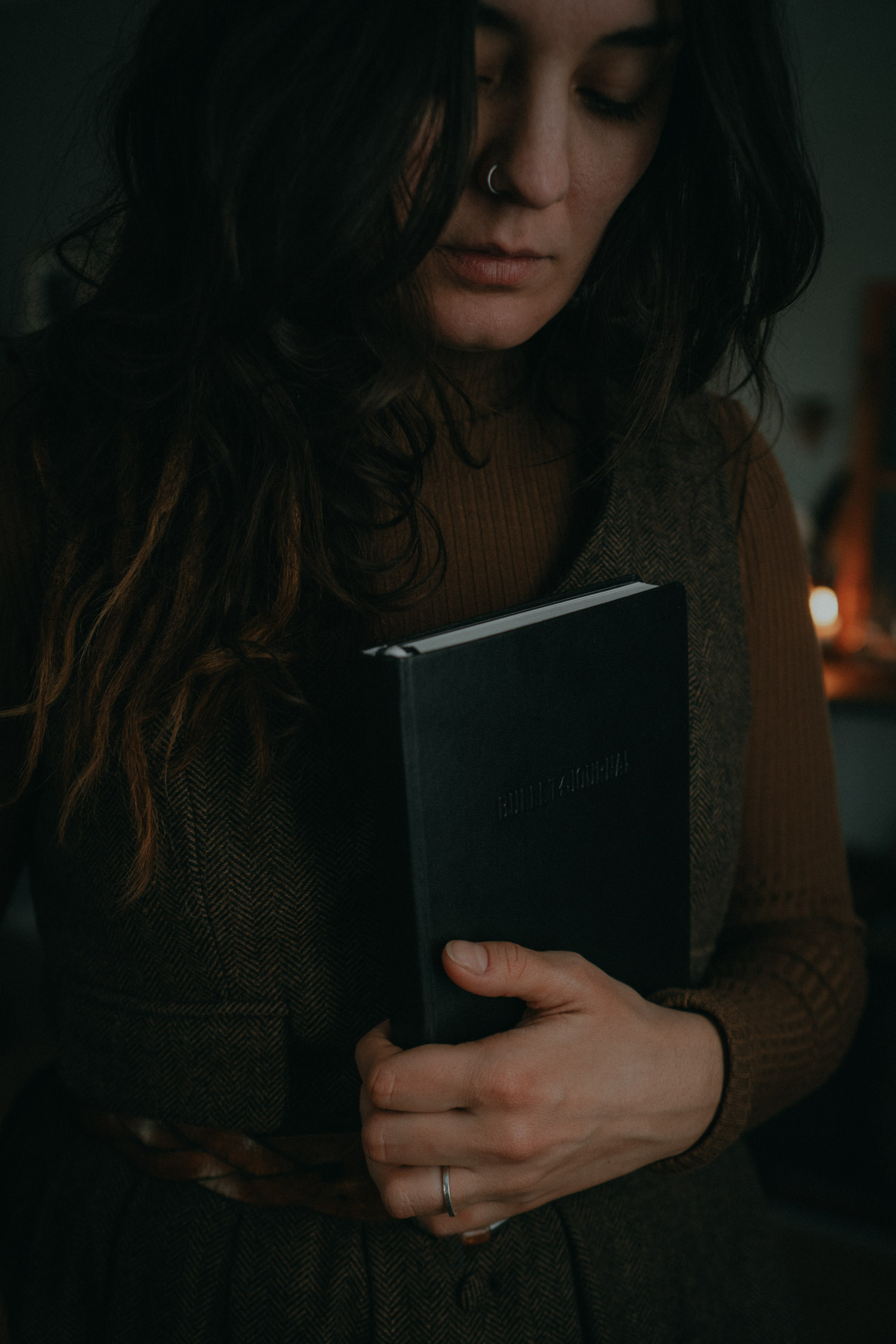 a woman holding a bullet journal