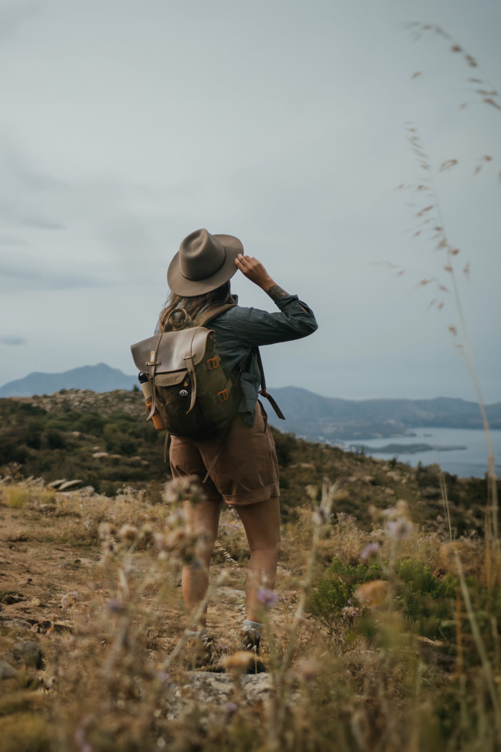 outdoorsy woman with a hat watching a sea view in Spain