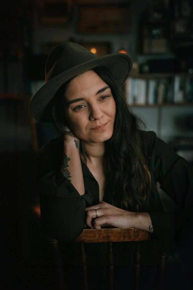 Portrait of a dark haired woman in a stetson hat