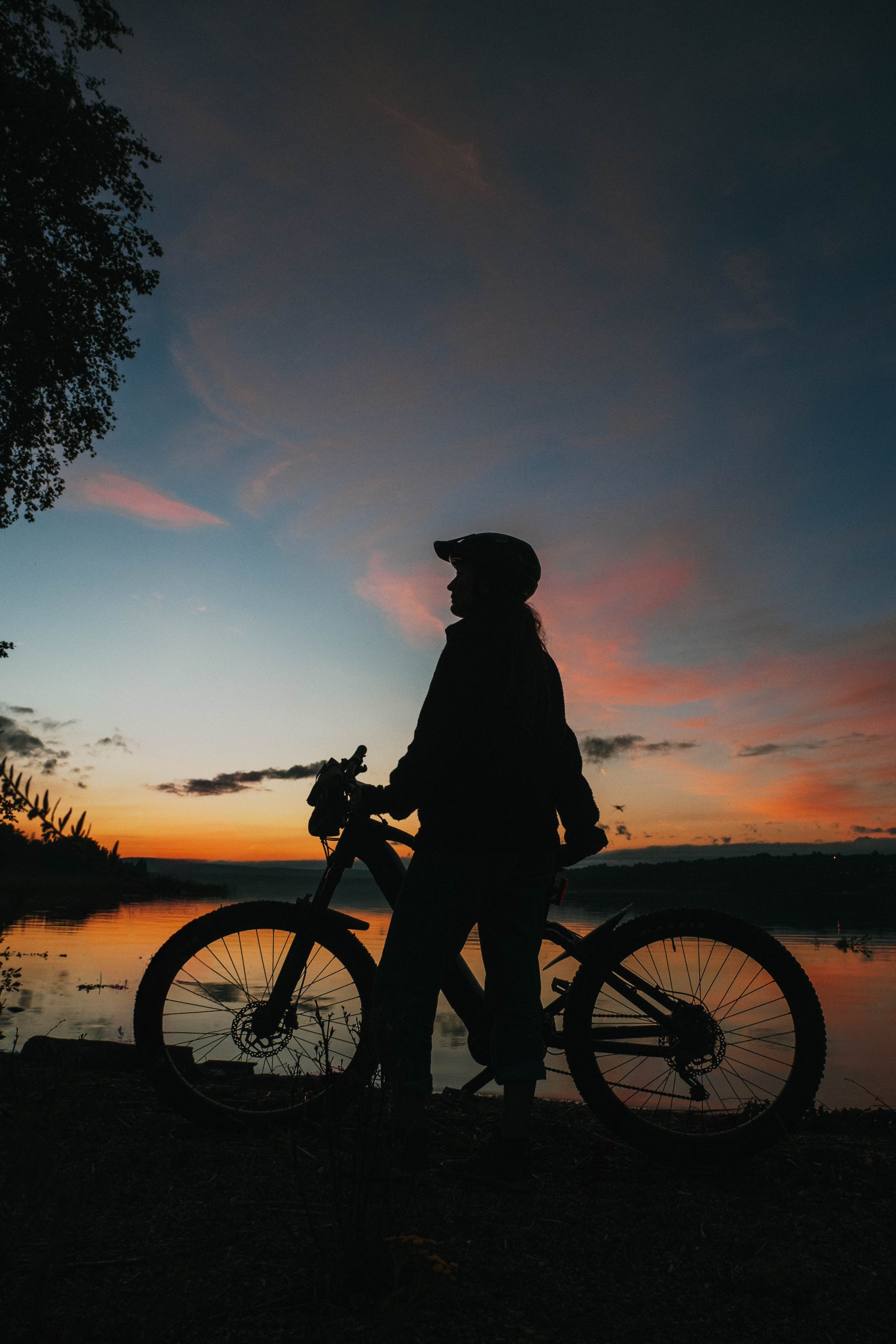 silhouette of female with her mountainbike
