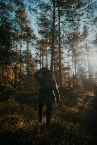 woman walking through a forest